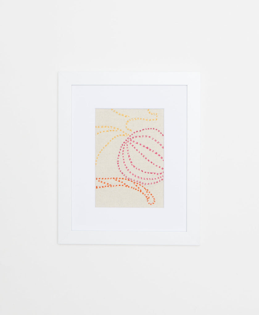 Handcrafted Artisan textile framed artwork featuring pink, yellow and orange stitching on a white background 