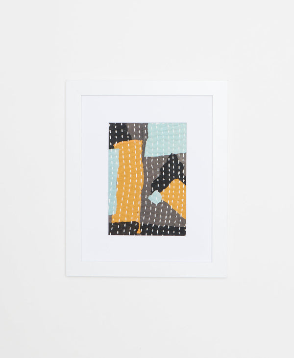 Handcrafted Artisan-made framed textile artwork featuring a geometric blue, yellow, and grey design. 
