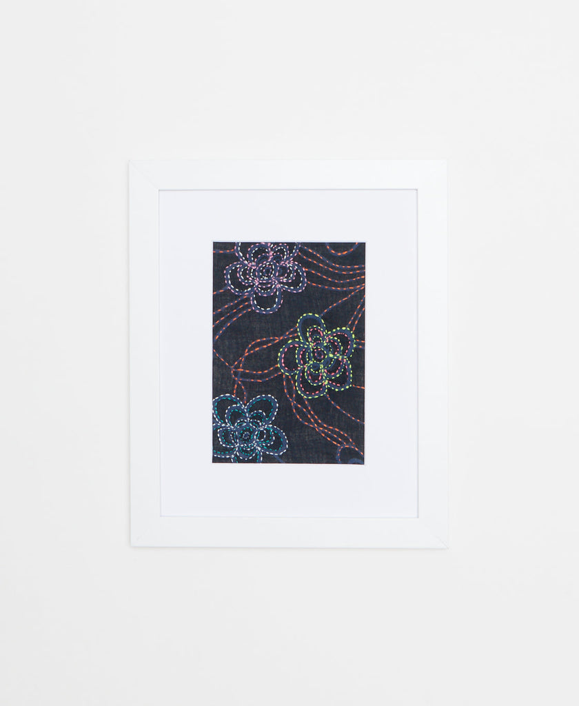Handcrafted artisan-made textile framed artwork featuring a floral design on a black background 