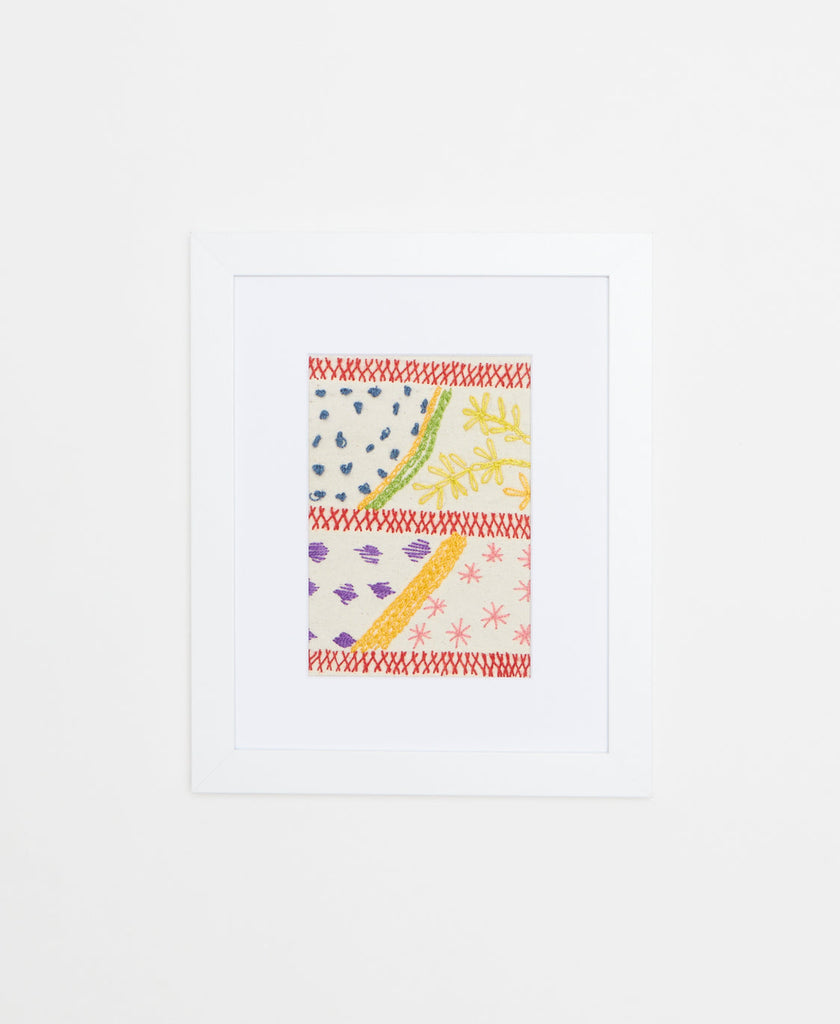 Handcrafted artisan-made famed textile art featuring a hybrid dot, line, and floral design on a white background 