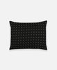 small black cross-stitch accent pillow with hand-stitched embroidery
