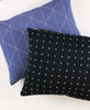 black and blue throw pillows with hand-embroidered geometric patterns