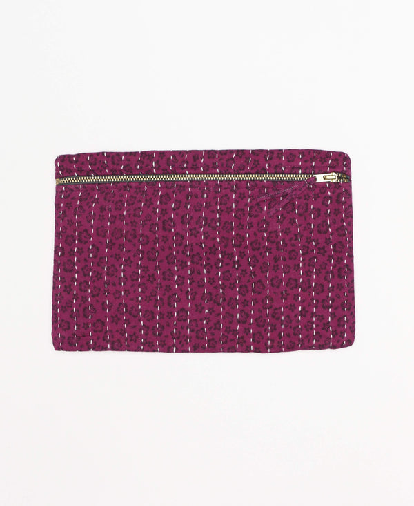 bright magenta small pouch that features a subtle floral pattern 