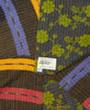 dark brown and navy quilt with bright green flowers and purple, red, and orange stripes