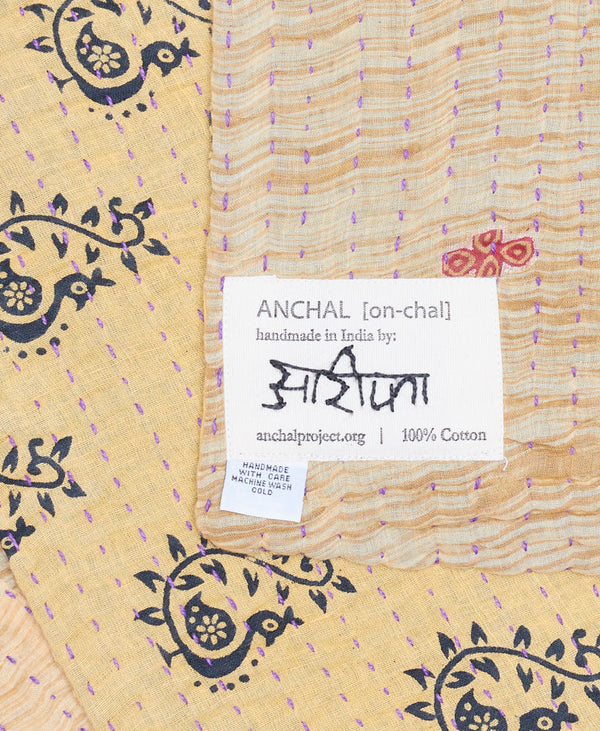 small lap quilt by anchal project featuring the signature of the artisan
