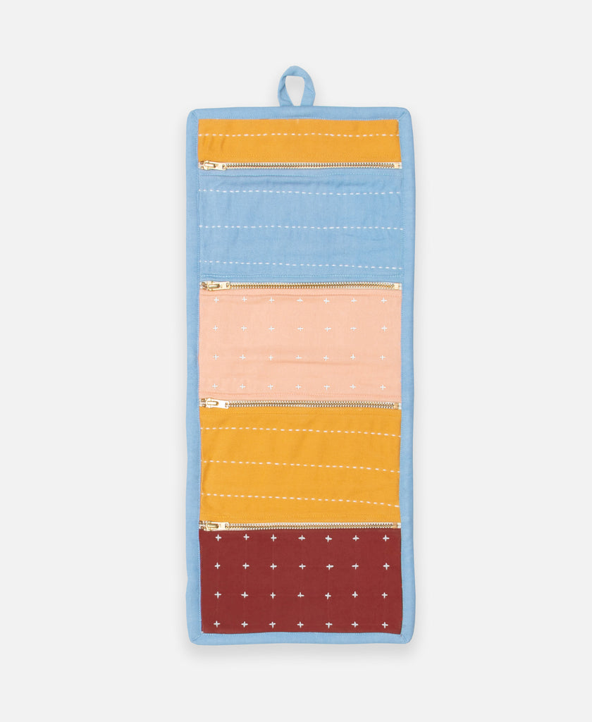 Peach, blue, yellow, and red travel organizer