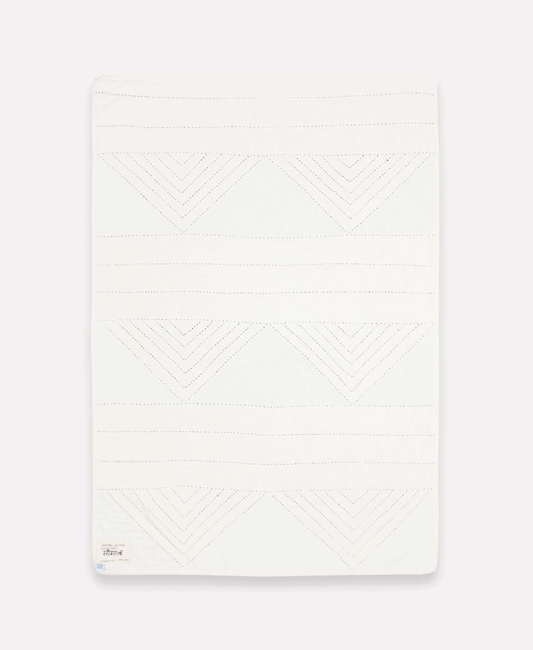 modern small quilt throw with geometric triangle pattern by Anchal