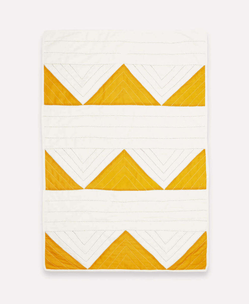 hand quilted organic cotton baby blanket with mustard yellow triangles