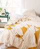 all white mustard and yellow children's room with Anchal's Small Triangle Quilt Throw