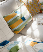 stamp throw pillow and katha quilt on a pale grey couch with white Anchal Project pillows