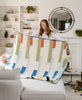 modern artisan-made red, green, white, yellow, and blue striped quilt