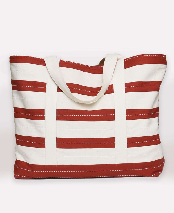 Rust and white colored weekend bag made from organic cotton and made by Fair Trade artisans 