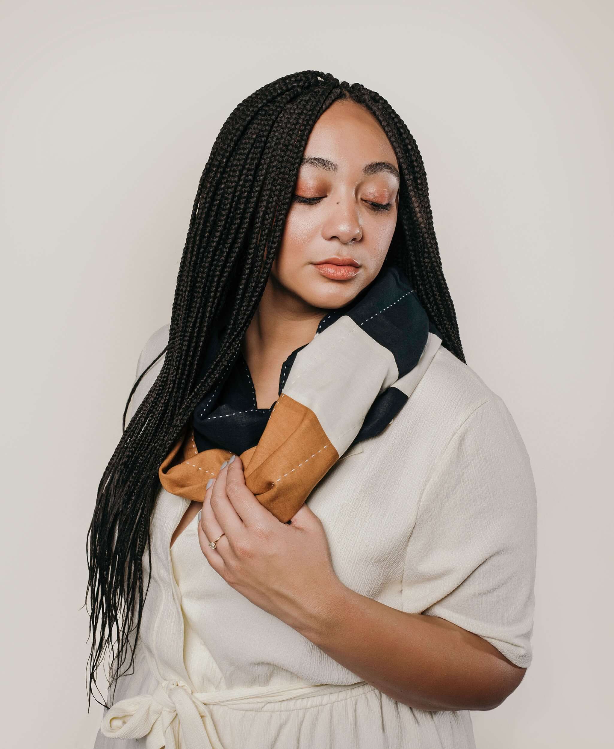 model wearing Anchal Project stripe infinity scarf made from organic cotton