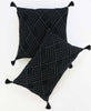 pair of black modern organic cotton pillows with tassels