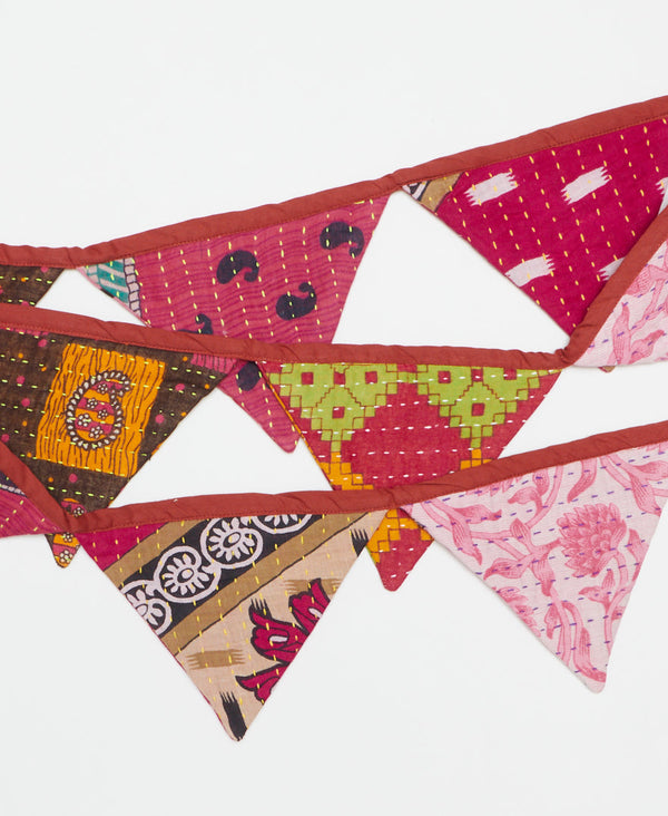 in hues of pink and red, this sustainable triangle garland is the perfect decor for any party 