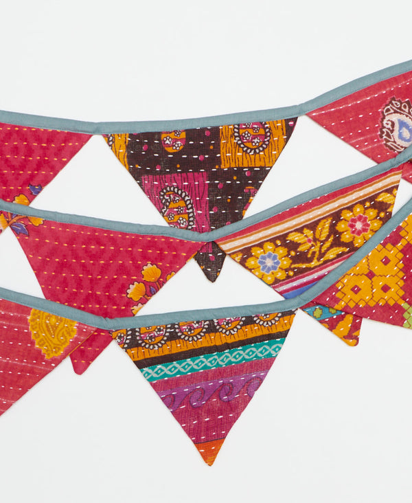 in hues of pink and orange, this zero waste triangle garland is the perfect sustainable decor 