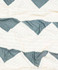 soft organic cotton quilt with geometric triangle pattern in spruce green and white
