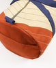 Detail of quilted weekender duffel bag in rust color made of organic cotton