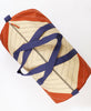 Top view of triangle pattern in quilted weekender duffel bag in rust color made of organic cotton