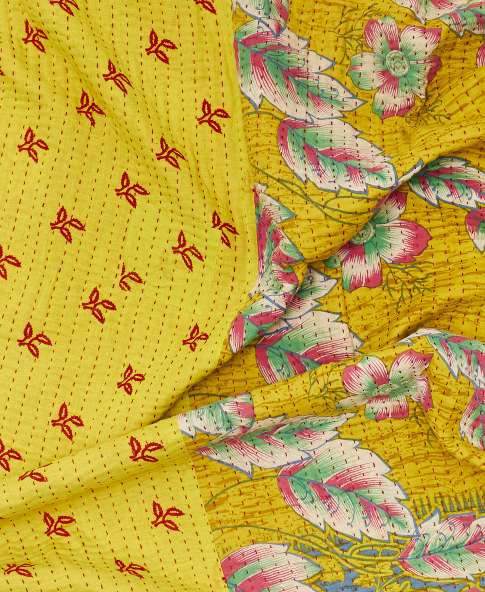 Red, yellow, and pink floral eco friendly quilt throw created using repurposed saris 