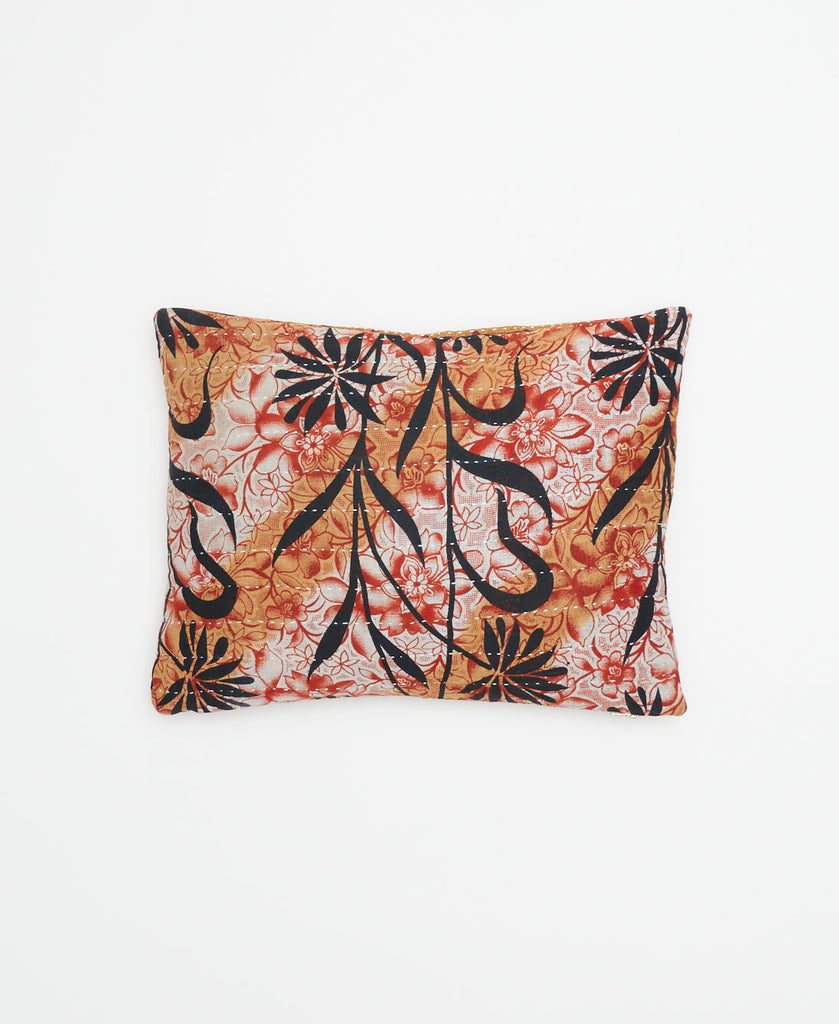 tan ecofriendly accent pillow with black and red flowers with white stripes