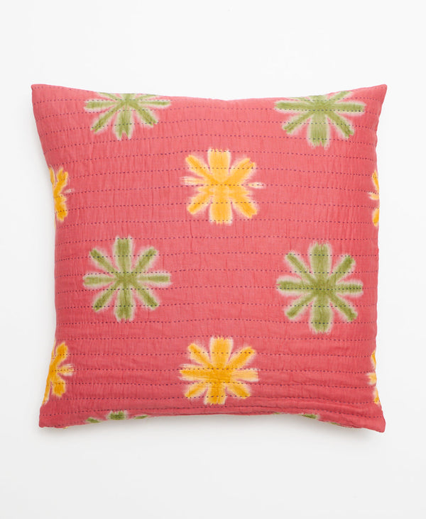 Opposite side of pillow featuring a green and yellow large floral print on a red base
