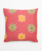 Opposite side of pillow featuring a green and yellow large floral print on a red base