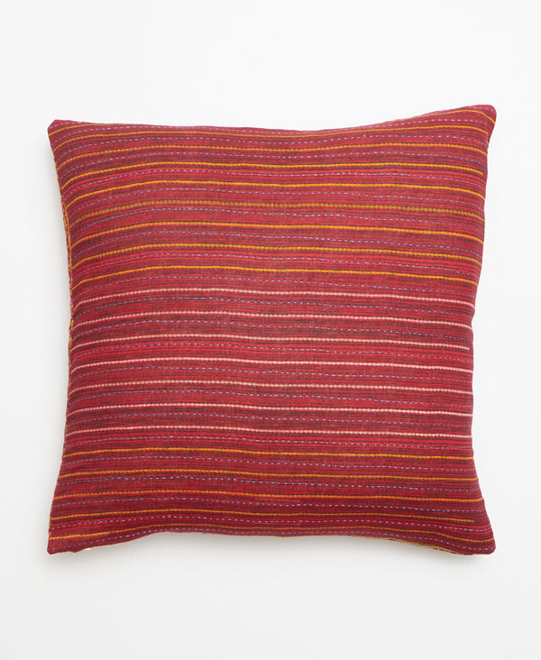 Opposite side of the pillow featuring a multicolored stripe pattern 
