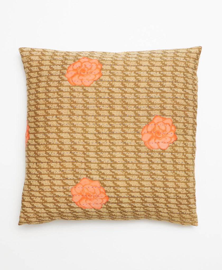 Vintage kantha throw pillow featuring a minimal peach floral design on a tan and white patterned background 