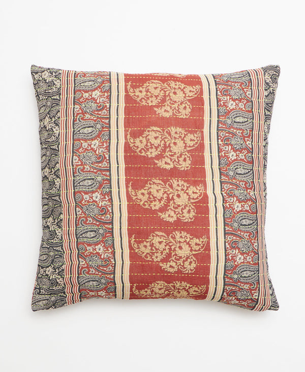 Opposite side of pillow featuring a red, black, and beige pattern through out 