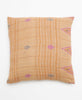 Opposite side of pillow featuring a beige and white stripe pattern with pink triangle details 