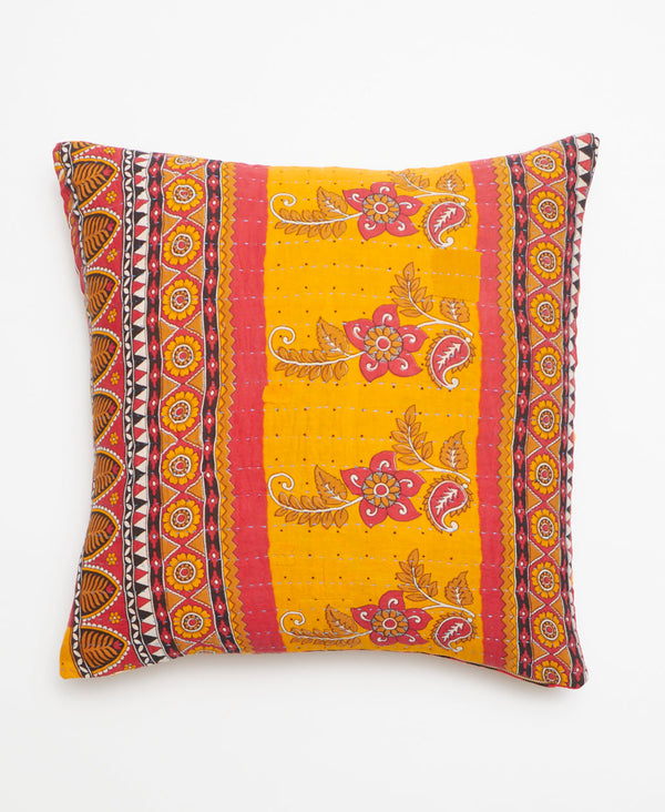 Opposite side of pillow featuring a red, white, and yellow floral and abstract design