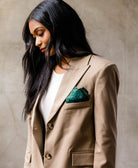 woman in camel blazer wearing an Anchal vintage silk pocket square in her pocket